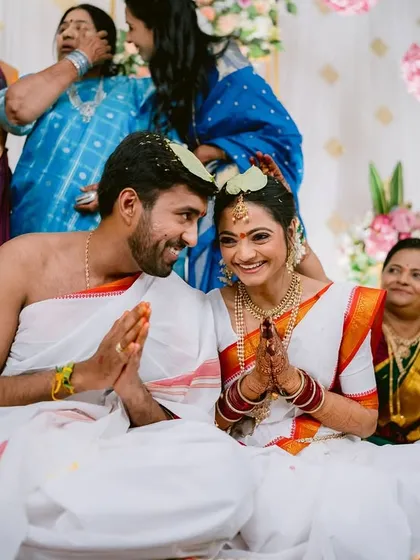 A sweet moment of shared prayer and smiles between Aditi and Rishabh during their wedding.