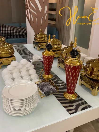 An overhead view of the buffet table, showing the complete arrangement of serving dishes, plates, bowls, and decorative elements.
