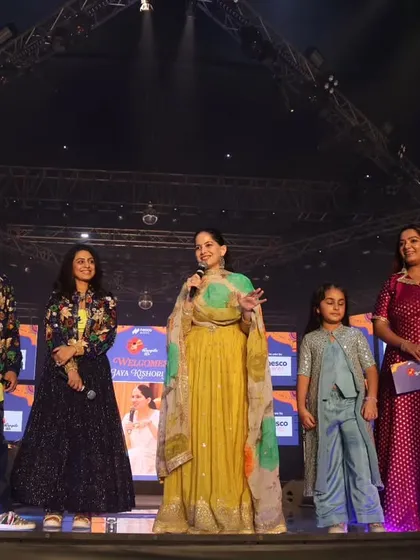 A wide shot of the stage with Parthiv Gohil, Manasi Parekh, and Jaya Kishori. Hosting such a talented lineup is a responsibility I handle with professionalism and joy.