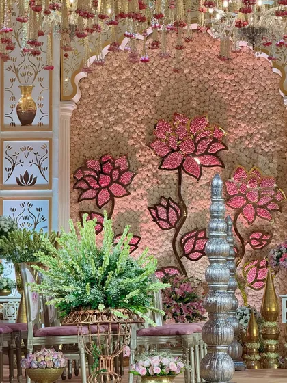 A detail shot of the mandap, focusing on the traditional silver decor and the beautiful lotus-themed backdrop. It's a perfect symphony of blooms, brass, and elegance. 🌸