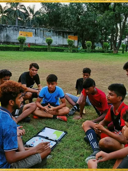 We believe a smart player is a strong player. Here, we are using a tactical board during a session to discuss game strategy, positioning, and on-field communication. This is how we build game awareness.