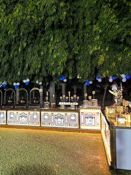 Another view of our illuminated catering counter at a nighttime event. The blue and white balloons in the background indicate a celebration, and our setup complements the festive mood perfectly.