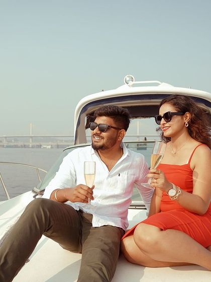 A fun, candid shot of the couple toasting with champagne on the yacht. These are the joyful, unscripted moments that truly tell your story.