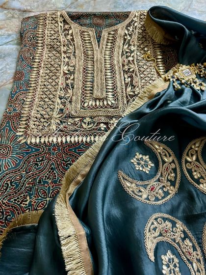 Another perspective of the ensemble, highlighting the rich patterns of the modal silk fabric and the luxurious gold embroidery.