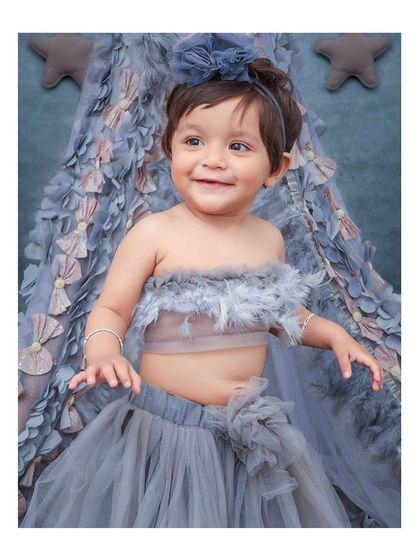 A full view of the beautiful feather-themed outfit and teepee backdrop. I take care of all the styling, including unique costumes and props.