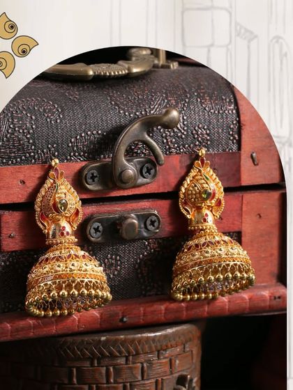 Discover the radiance of our latest jhumki collection. These antique-finish earrings with coloured stones are designed to shine, making them a perfect festive accessory.