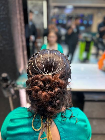 A close-up of the finished messy bun with the beautiful hair accessory. This style is intricate yet looks effortlessly chic.
