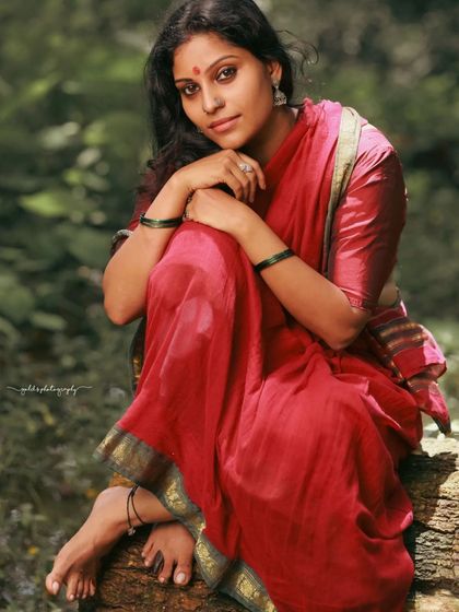 A rustic, village-themed series inspired by the movie 'Kanthara'. The model is styled in a simple red saree, captured in a natural, watery landscape to evoke a sense of raw, earthy beauty.