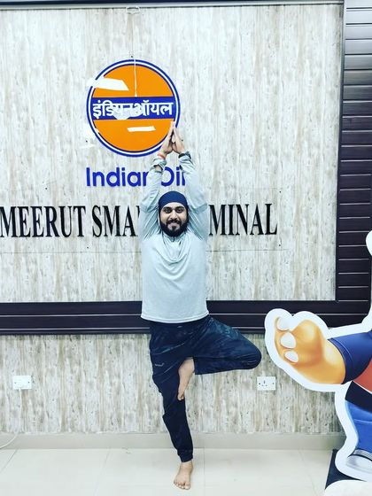 Striking a Vrikshasana (Tree Pose) at the Indian Oil office in Meerut. Yoga can be practiced anywhere!