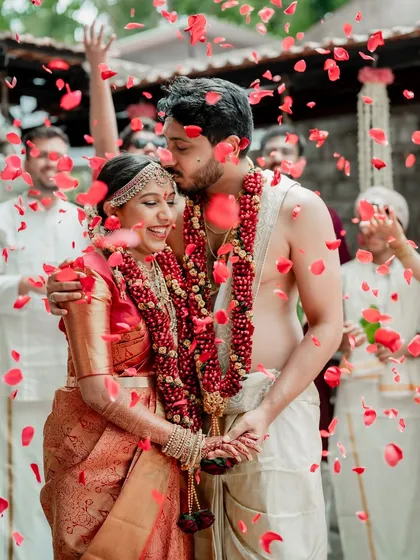 A quiet moment of love amidst a shower of rose petals. Our story-driven approach focuses on these small, heartfelt interactions that tell the bigger story of your connection.