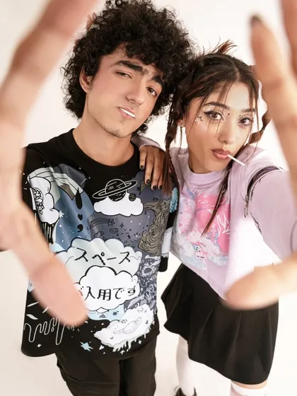 A fun, interactive shot of two models, framed by their hands. This image captures the youthful, social energy of the streetwear brand.