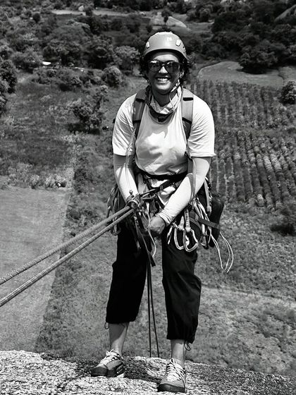 A beautiful black and white portrait of Gopika, geared up and smiling after a climb. It captures her joy and passion for the sport.