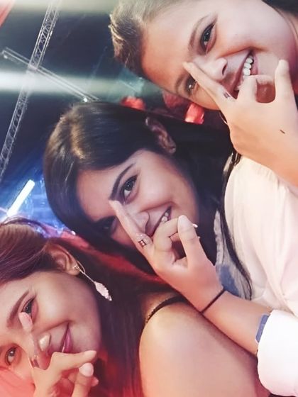 Friends showing off their matching finger tattoos.