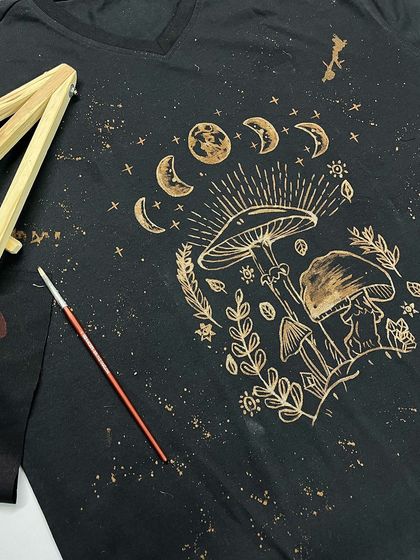 Can you believe this is not printed but hand-painted with bleach? This is a student's incredible work from one of my bleach art workshops, featuring mushrooms and moon phases.