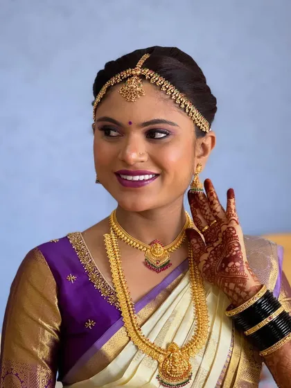 A happy, candid moment. The bride's makeup looks fresh and vibrant, highlighting her joyful expression.