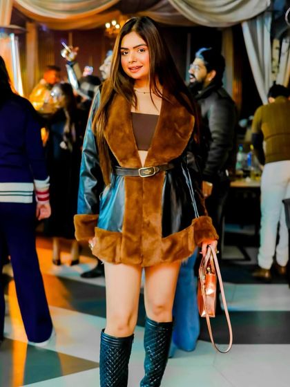A chic winter party outfit. This faux leather and fur coat is the perfect statement piece to elevate any look during the colder months.