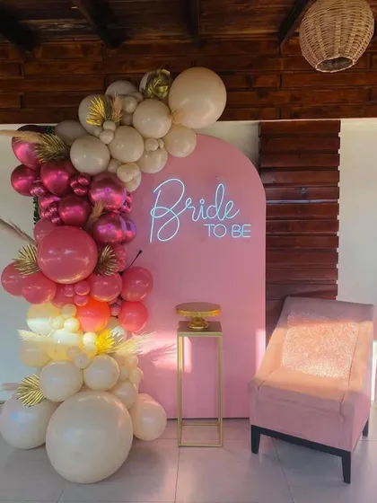 Celebrate the bride-to-be with this trendy and modern photo backdrop. I combined a custom neon sign with a vibrant, multi-toned balloon arch and gold accents to create the perfect spot for pictures and memories.