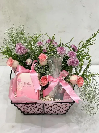 A simple and pretty Mother's Day gift: a black wire basket filled with fresh pink flowers and a 'Pretty' soap bar.