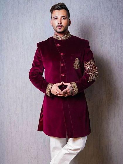 This full-length portrait showcases a modern take on the classic sherwani. The pose is confident and relaxed, demonstrating how traditional attire can be styled for a contemporary, fashionable look.