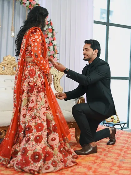 Another angle of the proposal, showing the groom's hopeful expression as he presents the ring. Capturing multiple perspectives ensures the full story of this moment is told.