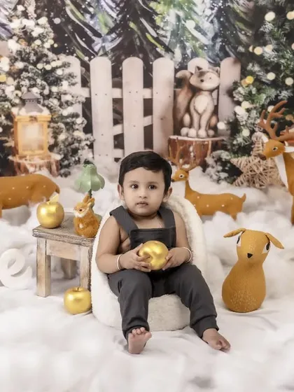 A quiet moment in a winter wonderland. This little one sits peacefully in our elaborate Christmas-themed set, surrounded by snow, reindeer, and twinkling lights.