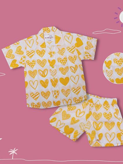 A closer look at our yellow heart print co-ord set for boys. The detailed graphic shows the fun pattern and breathable fabric.