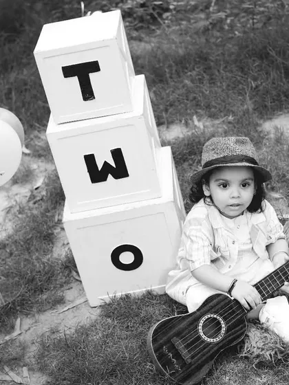 A direct and engaging black and white portrait of the two-year-old boy from his outdoor shoot.