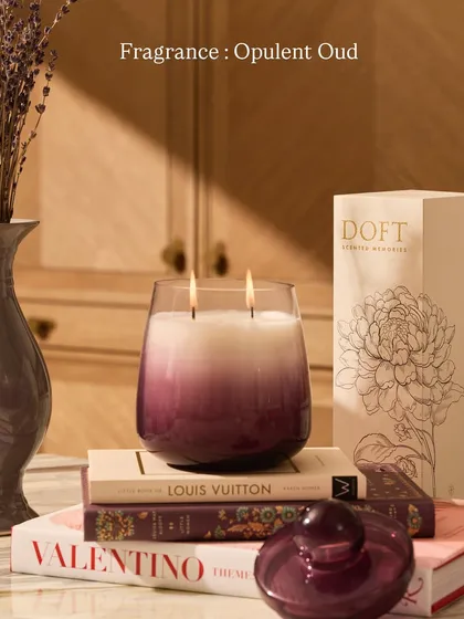 Embark on an olfactory journey to the heart of warmth with my Opulent Oud fragrance. This candle, in its purple ombre glass, is perfect for styling on a stack of your favorite books.