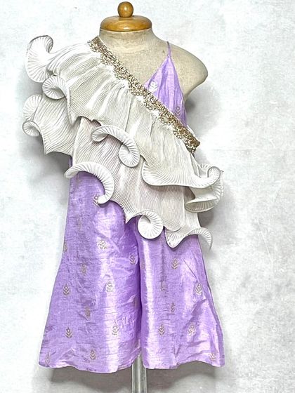 A full look at the lavender frill jumpsuit. The pants have a subtle gold print, while the pleated and curled dupatta adds a touch of high-fashion drama.