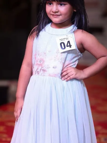 A confident pose from a 6-year-old model on the runway, submitted for her online audition.