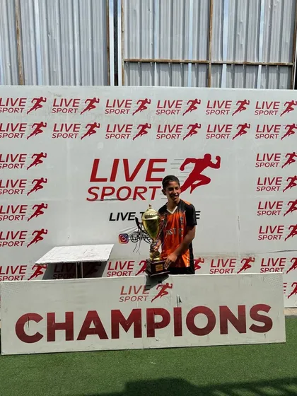 A lone champion. One of our U13 players with the trophy after a successful tournament.