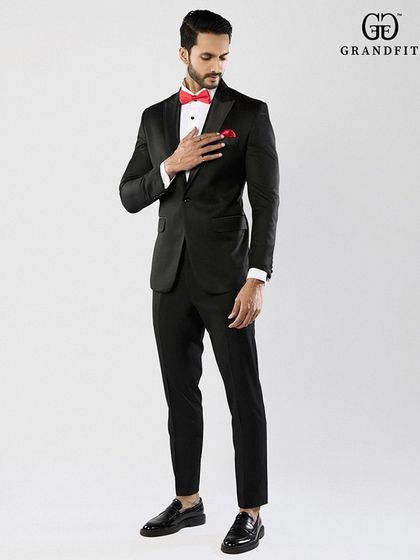 A full-length view showcasing the elegant proportions of our bespoke tuxedos. The trousers are tailored for a clean, modern line that complements the jacket perfectly.