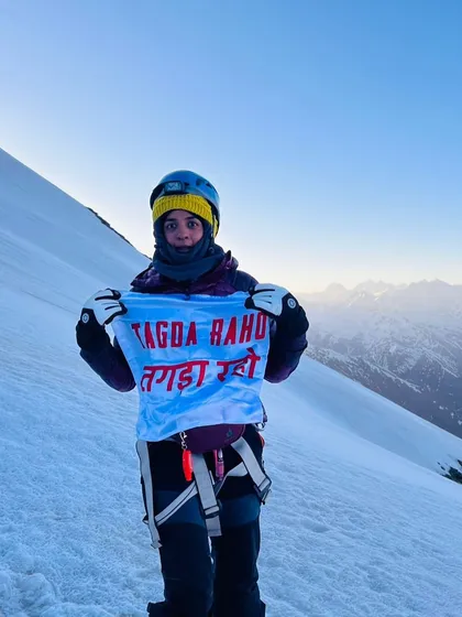 Some people ask if our training builds biceps. We believe it builds the strength to conquer mountains, literally. One of our members holding our flag high after a gruelling climb is proof that this is more than a workout; it's practice for life's biggest challenges.