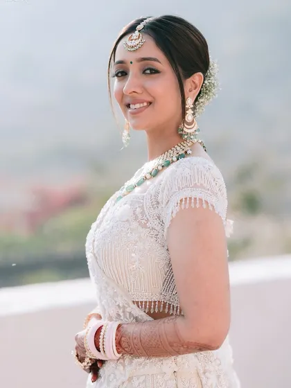 A radiant bridal portrait of Sakshi in Pushkar. Her bright, happy smile and the beautiful natural light make this a simple yet stunning shot that captures her bridal glow.