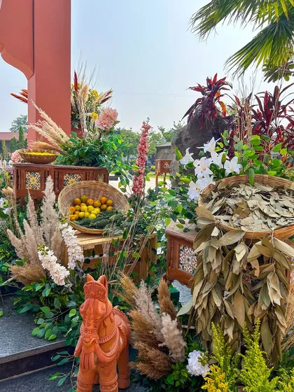 A terracotta horse statue stands among baskets of bay leaves and fresh fruit, showcasing the unique and detailed props we use to build an immersive environment.