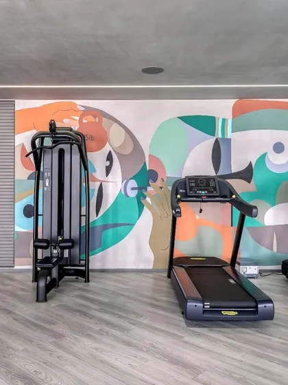 A duplicate image of the mural with gym equipment.