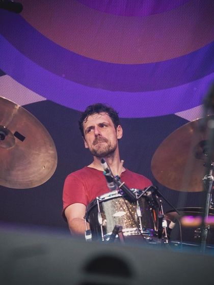 Our drummer, focused and in the zone at the Jetlag Music Festival. The rhythm section is the heartbeat of our band, driving the energy of our live shows.