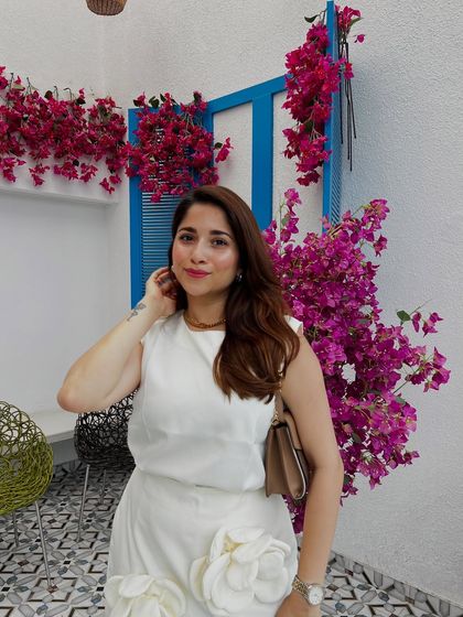 Another look at this elegant white dress. The simple silhouette is elevated by the 3D floral details, making it a perfect brunch or day-event outfit.