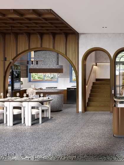 Materiality is key to defining spaces without walls. In this design, I used a palette of wood, terrazzo, and metal to delineate the dining and kitchen areas. The repetition of arches in the wood paneling and doorways creates a sense of rhythm and flow.