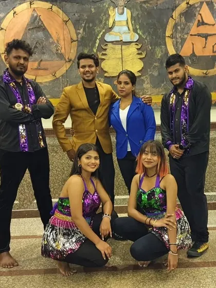 The core members of our performance troupe taking a moment for a photo backstage. Their dedication is key to our success.