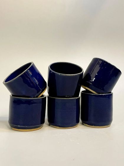 Elevate your everyday sipping experience with these handmade ceramic tumblers in a deep cobalt blue. Crafted with passion, each tumbler is a testament to the beauty of handmade craftsmanship.