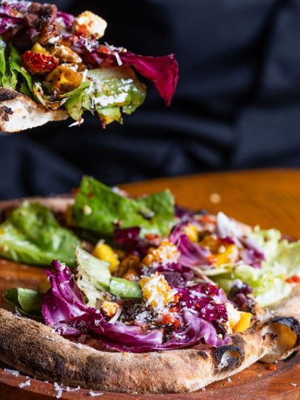 Can't choose between a pizza or a salad? I'll bring you both. This is my pizza salad, a crispy pizza crust topped with fresh greens, feta, and more.