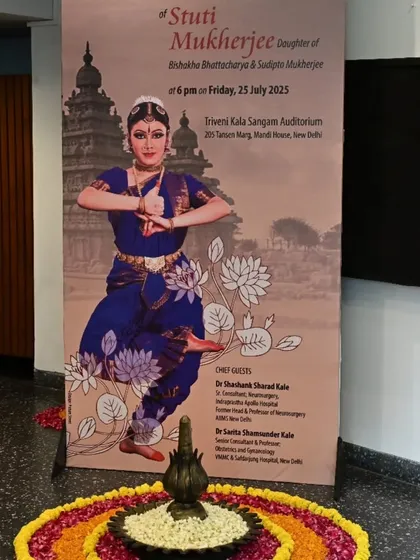 The welcome banner for Stuti Mukherjee's arangetram at the Triveni Kala Sangam in New Delhi. The entrance is decorated with a traditional rangoli, setting a festive tone for the debut performance.