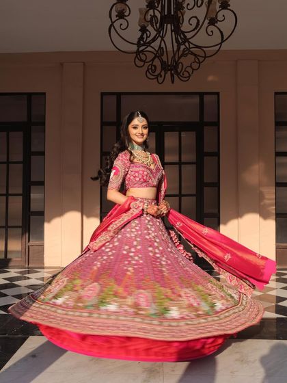 A classic twirl shot that captures the movement and beauty of the bride's lehenga. Her radiant makeup ensures she is glowing from every angle.