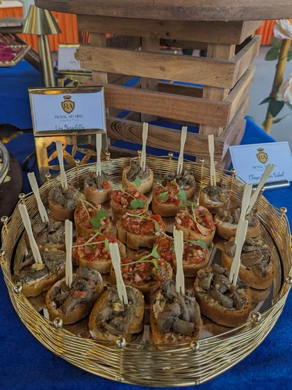 My bruschetta selection offers a variety of toppings to please every palate. Served on a golden wire tray, this assortment includes classic tomato and basil as well as a rich mushroom topping, all on perfectly toasted bread.