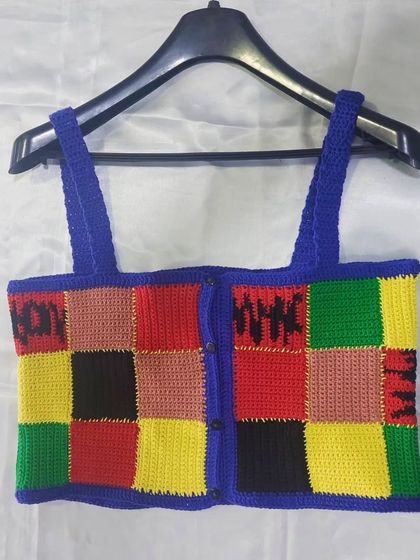 My handmade patchwork top on a hanger, ready to be shipped to a new home. I love creating these unique, pop-culture inspired pieces.