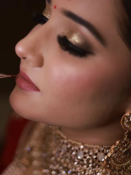Another angle of the lip makeup application. This detailed work is crucial for achieving a crisp, professional finish on a bridal look.