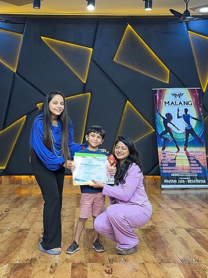 A young camper receives his certificate and trophy. These moments are what make the camp so rewarding, boosting a child's self-esteem and leaving them with a tangible reminder of their achievements.