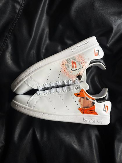 A top-down view of the Lando Norris custom sneakers, showing the artwork on both shoes.