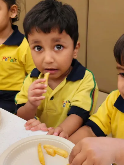 A close-up of a student enjoying the meal provided during their school outing. We ensure all food is fresh, hygienic, and tasty.